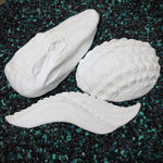 White resin alligator cast on a speckled black and green surface