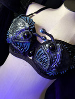 Black and blue bra with fish design on a mannequin