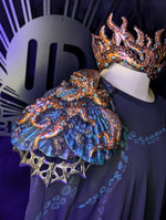 Decorative headpiece with intricate designs on a dark background