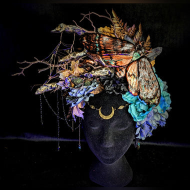 Decorative headpiece with flowers and butterflies on a black background
