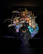 Decorative headpiece with flowers and butterflies on a black background