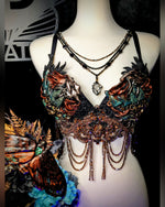 Decorative necklace on a mannequin with intricate designs and colorful elements.