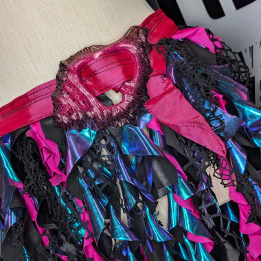 Close-up of a colorful, textured fabric with pink, black, and blue patterns. Ren Faire Belt mermaid