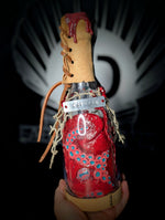 Hand holding ID fabrications OCtopus in a bottle with metal name tag