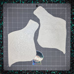 Two white textured chest pices on a gray cutting mat with measurements.
