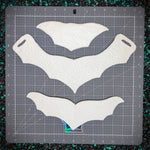 White Chest Pieces on a gray cutting mat with grid lines.