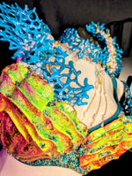 Colorful coral-like structure with blue and multicolored elements on a dark background