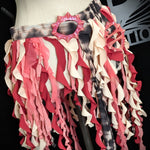 Mannequin wearing a colorful ruffled skirt with a brand logo in the background