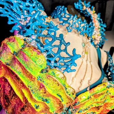 Colorful coral-like structure with blue and multicolored elements on a dark background