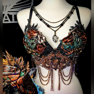 Decorative necklace on a mannequin with intricate designs and colorful elements.