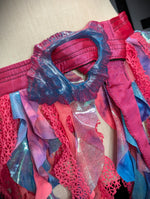 Colorful fabric with blue and pink patterns on a beige background