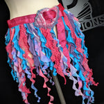 Colorful ruffled skirt on a mannequin against a dark background