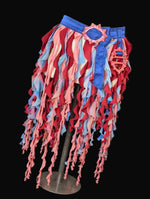 Colorful skirt with red and blue patterns on a mannequin against a black background