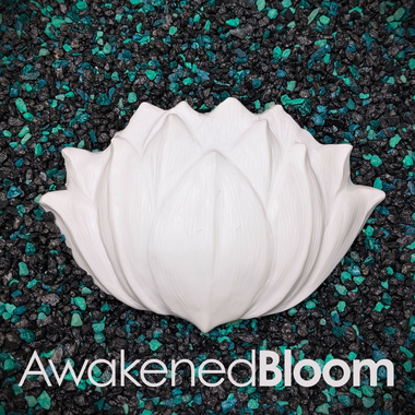 Four white sculpted lotus flower mermaid top DIY pieces arranged on a dark textured background with green and black pebbles. Each flower has a text label overlay: 'AwakenedBloom', 'GatheringBloom', 'KindredBloom', 'FirstBloom', and 'MorningBloom'.
