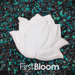 A white, flower-shaped DIY plastic mermaid top part with a smooth, matte finish, displayed on a bed of small black and green gravel. The text 'FirstBloom' is printed in white at the bottom.