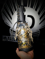 Hand holding ID fabrications OCtopus in a bottle with metal name tag