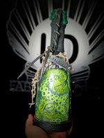 Hand holding ID fabrications OCtopus in a bottle with metal name tag