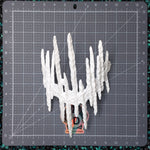 A white, highly textured hand sculpted crown or headdress with tall, jagged spikes, displayed on a gray grid cutting mat. The item is shown from a top-down view, with a small 'Found Image Fabritations' sticker visible at the base.