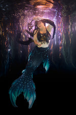 Mermaid holding bone fish fans underwater in the Stillwater by ID Fabrications 